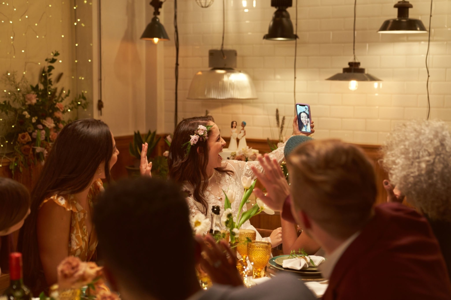 Lesbian wedding party with a friend on a video call